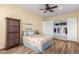 Bedroom with wood floors, ceiling fan, and walk-in closet at 20404 W Crescent Dr, Buckeye, AZ 85396