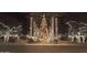 Festive community entrance adorned with palm trees and holiday lights at 20404 W Crescent Dr, Buckeye, AZ 85396