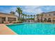 Relaxing pool area with palm trees and a fountain at 20404 W Crescent Dr, Buckeye, AZ 85396