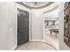 Elegant entryway with dark gray door and tile flooring at 20404 W Crescent Dr, Buckeye, AZ 85396