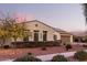 House with solar panels, two-car garage, and autumn-colored trees at 20404 W Crescent Dr, Buckeye, AZ 85396