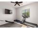 Home gym with treadmill, weights, and weight bench at 20404 W Crescent Dr, Buckeye, AZ 85396