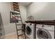 Laundry room with washer, dryer, espresso machine, and attic access at 20404 W Crescent Dr, Buckeye, AZ 85396