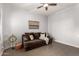 Cozy sitting room featuring a brown couch and tasteful wall art at 20404 W Crescent Dr, Buckeye, AZ 85396