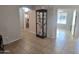 A well-lit hallway showcasing a glass-front curio cabinet at 2101 S Meridian Rd # 274, Apache Junction, AZ 85120