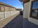 Side yard with gravel landscaping and white fence at 2101 S Meridian Rd # 274, Apache Junction, AZ 85120