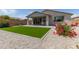 Landscaped backyard featuring artificial turf, desert landscaping and a covered patio at 2837 W Minton St, Phoenix, AZ 85041