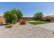 Beautiful backyard featuring desert landscaping, artificial turf, brick pavers, and mature trees at 2837 W Minton St, Phoenix, AZ 85041