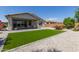 This backyard features artificial turf, desert landscaping, and a covered patio at 2837 W Minton St, Phoenix, AZ 85041