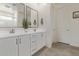 Bathroom with double sinks, white cabinets, tile flooring, and framed mirrors at 2837 W Minton St, Phoenix, AZ 85041
