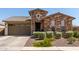 One-story home with stone exterior, two-car garage, and landscaping at 2837 W Minton St, Phoenix, AZ 85041