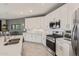 Stylish kitchen features stainless appliances, white cabinets, quartz countertops, and a tile backsplash at 2837 W Minton St, Phoenix, AZ 85041