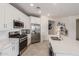 Modern kitchen with stainless steel appliances, white cabinets, and quartz countertops at 2837 W Minton St, Phoenix, AZ 85041