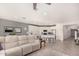 Open-concept living area with tile floors, a large sofa, and an adjacent kitchen space at 2837 W Minton St, Phoenix, AZ 85041