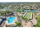 Aerial view of a community pool, tennis courts, sand volleyball, with lush green landscaping at 3721 N 150Th Ct, Goodyear, AZ 85395