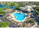 Aerial view of a community pool with lounge chairs, gazebos, and lush green landscaping at 3721 N 150Th Ct, Goodyear, AZ 85395