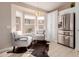 Bright breakfast nook featuring a stainless steel refrigerator, natural light, and comfortable seating at 3721 N 150Th Ct, Goodyear, AZ 85395