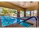 Indoor community pool with large windows and ample natural light, providing a relaxing environment at 3721 N 150Th Ct, Goodyear, AZ 85395