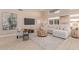 Inviting living room featuring a large sectional, media center, and light hardwood flooring at 3721 N 150Th Ct, Goodyear, AZ 85395