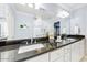 Bathroom with double vanity, granite countertop, and large mirror at 4034 E Osborn Rd, Phoenix, AZ 85018