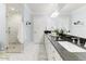 Bathroom with double vanity, granite countertop, and large shower at 4034 E Osborn Rd, Phoenix, AZ 85018