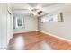 Well-lit bedroom with wood flooring and two windows at 4034 E Osborn Rd, Phoenix, AZ 85018