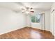 Light and airy bedroom with wood floors and a ceiling fan at 4034 E Osborn Rd, Phoenix, AZ 85018