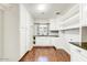 White laundry room cabinets, granite countertop, and wood flooring at 4034 E Osborn Rd, Phoenix, AZ 85018