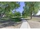 Walking path in a park with lush green trees and grass at 4034 E Osborn Rd, Phoenix, AZ 85018