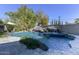 Stunning pool area with a rock waterfall and lush landscaping at 4034 E Osborn Rd, Phoenix, AZ 85018