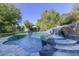 Relaxing pool and spa with a cascading waterfall feature at 4034 E Osborn Rd, Phoenix, AZ 85018