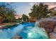 Inviting pool with waterfall feature and spacious patio area at 4034 E Osborn Rd, Phoenix, AZ 85018