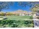 Picturesque community green space with lush lawn offering beautiful mountain views in a desirable Arizona neighborhood at 4711 N 212Th Dr, Buckeye, AZ 85396