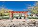 Inviting outdoor seating area featuring a stone base and shaded pergola perfect for enjoying Arizona's landscape at 4711 N 212Th Dr, Buckeye, AZ 85396