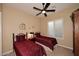 Cozy bedroom with two twin beds, a ceiling fan, and plantation shutters at 6217 E Sienna Bouquet Pl, Cave Creek, AZ 85331