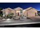 Beautiful desert home at night with attractive landscaping and lighting at 6217 E Sienna Bouquet Pl, Cave Creek, AZ 85331