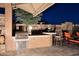 Outdoor kitchen with grill, bar seating, and patio area at 6217 E Sienna Bouquet Pl, Cave Creek, AZ 85331