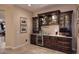 Elegant wet bar with granite countertop,wine storage, and beverage cooler at 6217 E Sienna Bouquet Pl, Cave Creek, AZ 85331