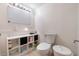 Clean bathroom with a toilet, sink, and storage at 755 W 2Nd St, Mesa, AZ 85201