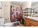 Well-appointed bathroom with Route 66 shower curtain and shelving at 755 W 2Nd St, Mesa, AZ 85201