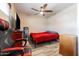 Bedroom with a red bed, gaming chair, and ceiling fan at 755 W 2Nd St, Mesa, AZ 85201