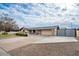 Front view of single story home with a long driveway and rustic gate at 755 W 2Nd St, Mesa, AZ 85201