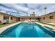 Large rectangular pool with surrounding patio and lounge area at 755 W 2Nd St, Mesa, AZ 85201