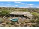 Stunning aerial view of a large home with a pool and mountain backdrop at 9784 E Miramonte Dr, Scottsdale, AZ 85262