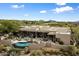 Aerial view showcasing a beautiful home, pool, and desert landscape at 9784 E Miramonte Dr, Scottsdale, AZ 85262