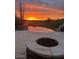 Enjoy the desert sunset in backyard with pool, stone border, and fire pit feature at 9784 E Miramonte Dr, Scottsdale, AZ 85262