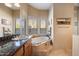 Bathroom features granite vanity and corner soaking tub at 9784 E Miramonte Dr, Scottsdale, AZ 85262