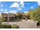 Front view of a beautiful home with a large courtyard and driveway at 9784 E Miramonte Dr, Scottsdale, AZ 85262