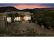 Evening view of home exterior, showcasing entryway and landscaping at 9784 E Miramonte Dr, Scottsdale, AZ 85262