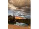 Breathtaking sunset view from infinity pool with desert landscaping and mountain vista at 9784 E Miramonte Dr, Scottsdale, AZ 85262